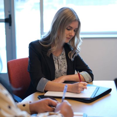 Blonde Woman Writing With Pen