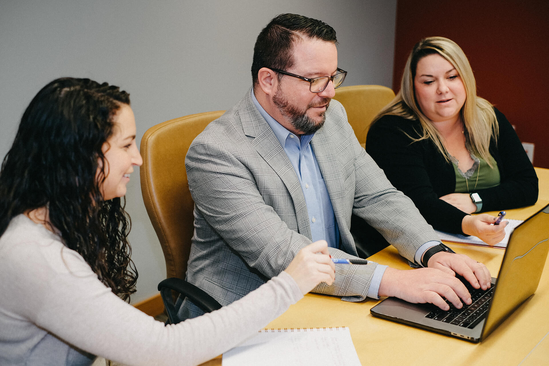 Colleagues Using Laptop In Meeting