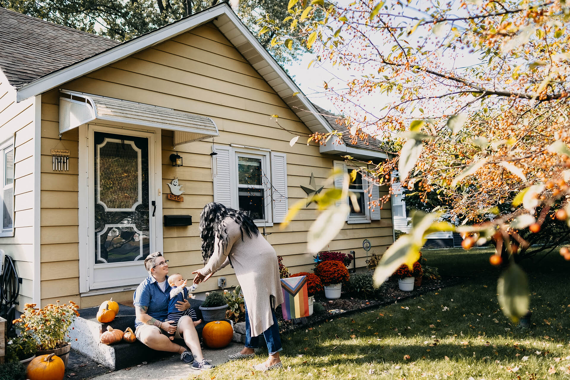 Family Outside Home In Autumn