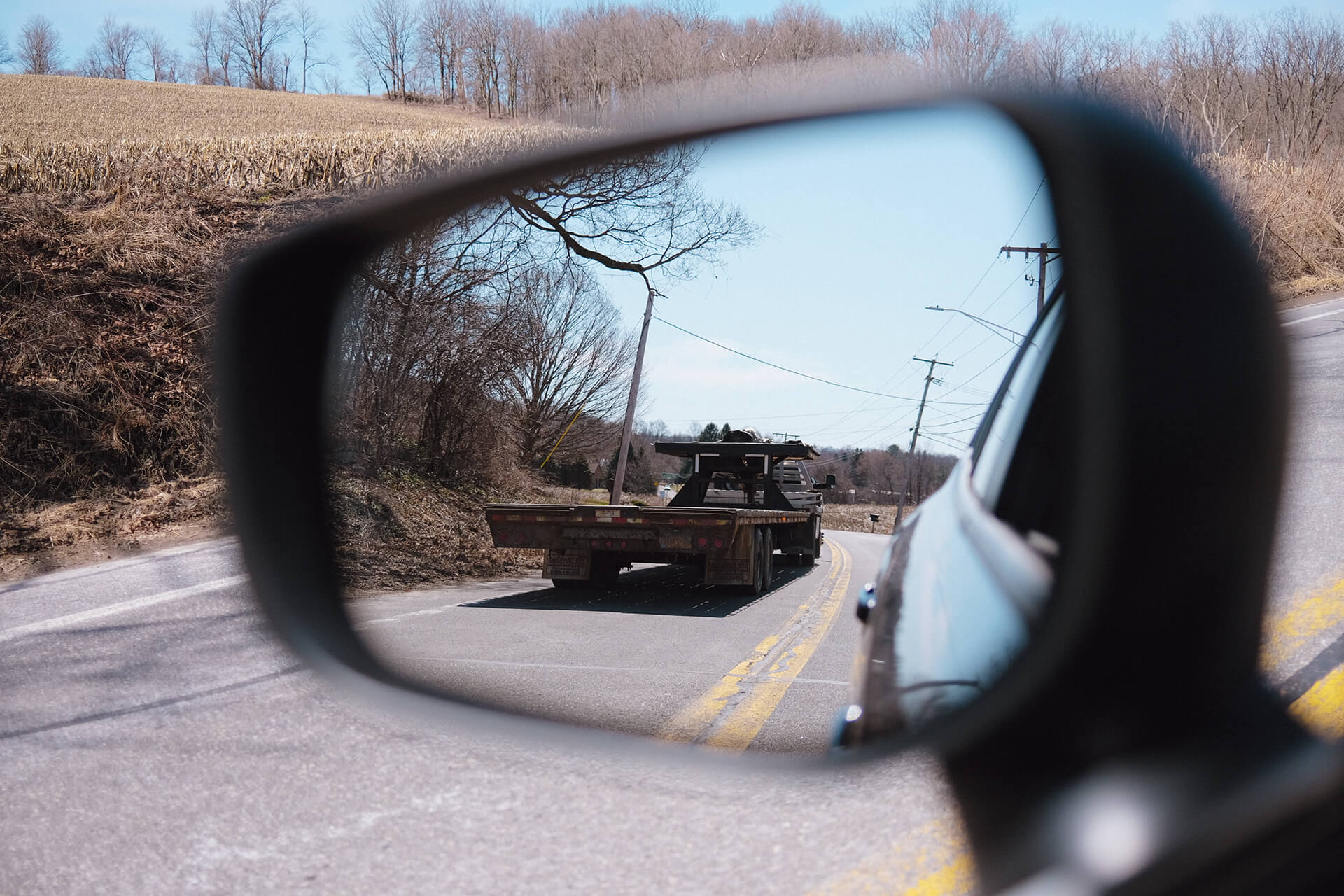Flatbed Truck In Side Mirror Of Car