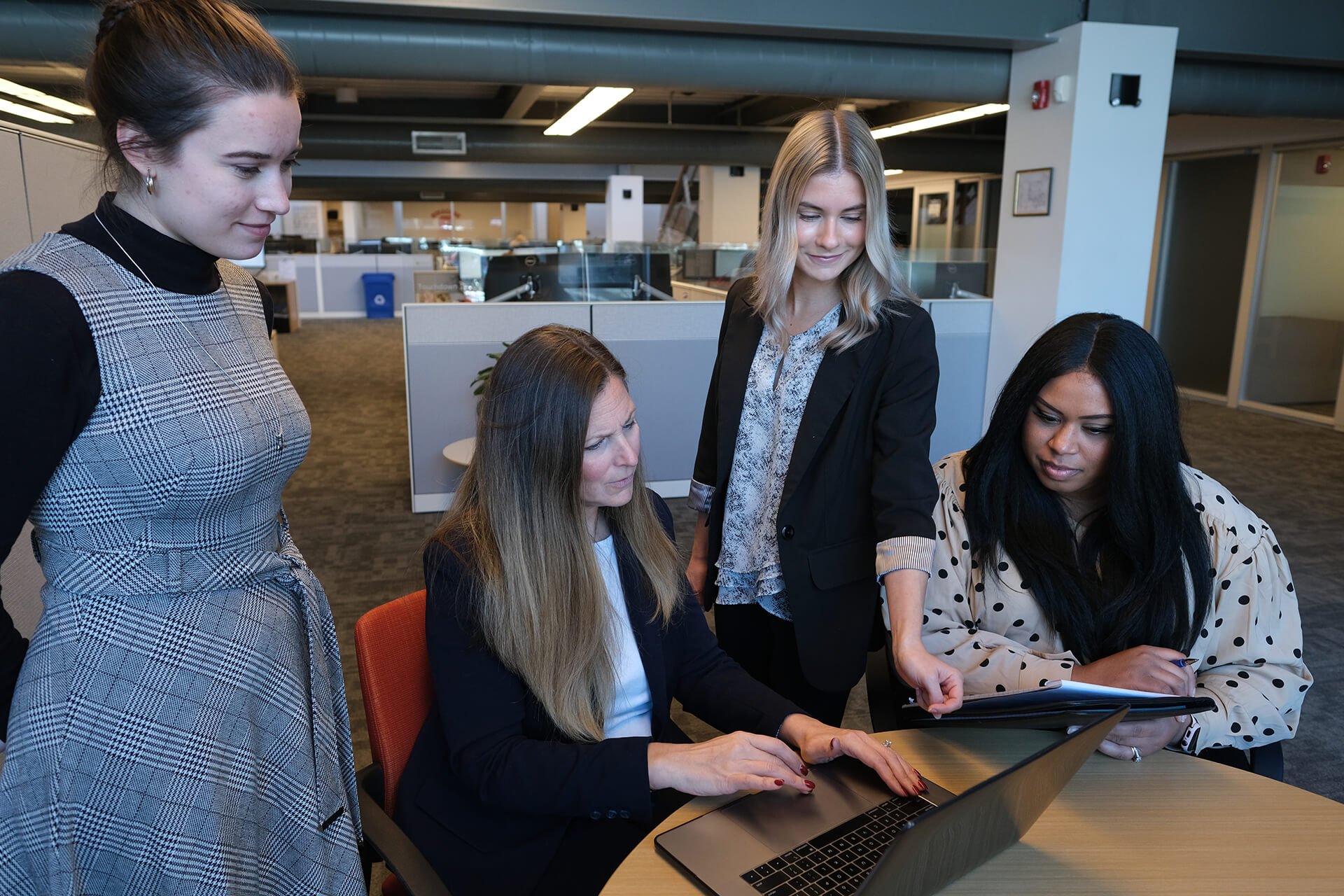 Four Women In Meeting Around Laptop