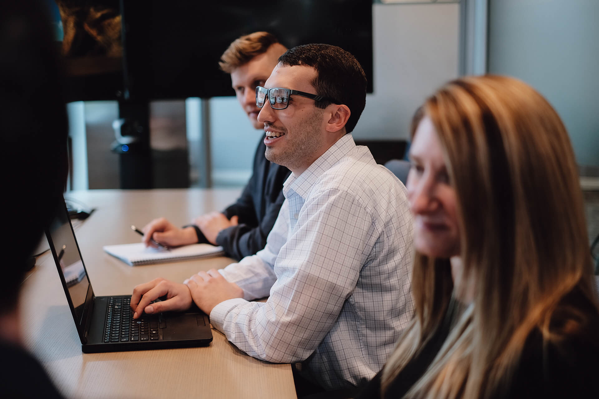 Man In Glasses Smiling In Meeting