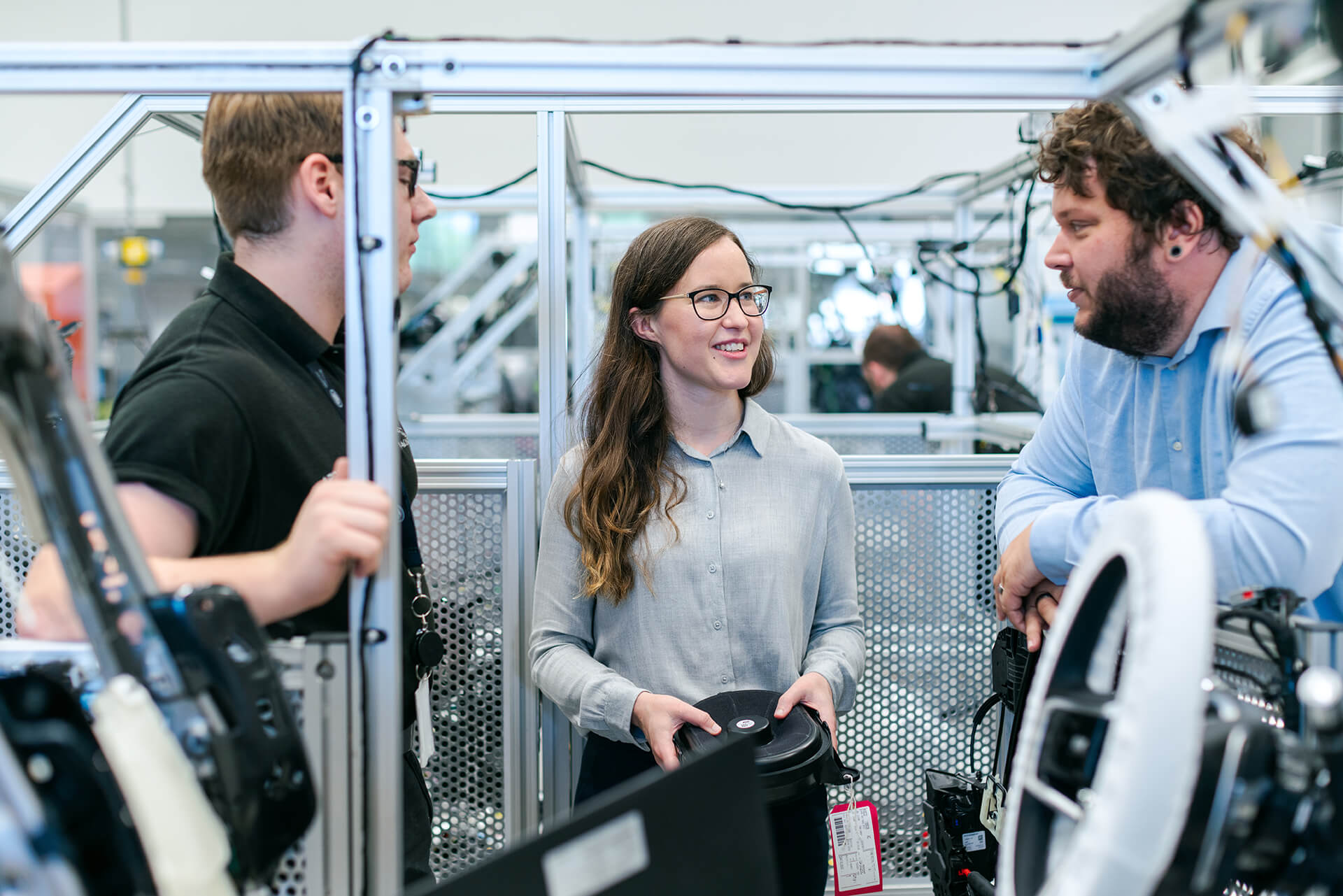 Three People Working With Electronic Parts