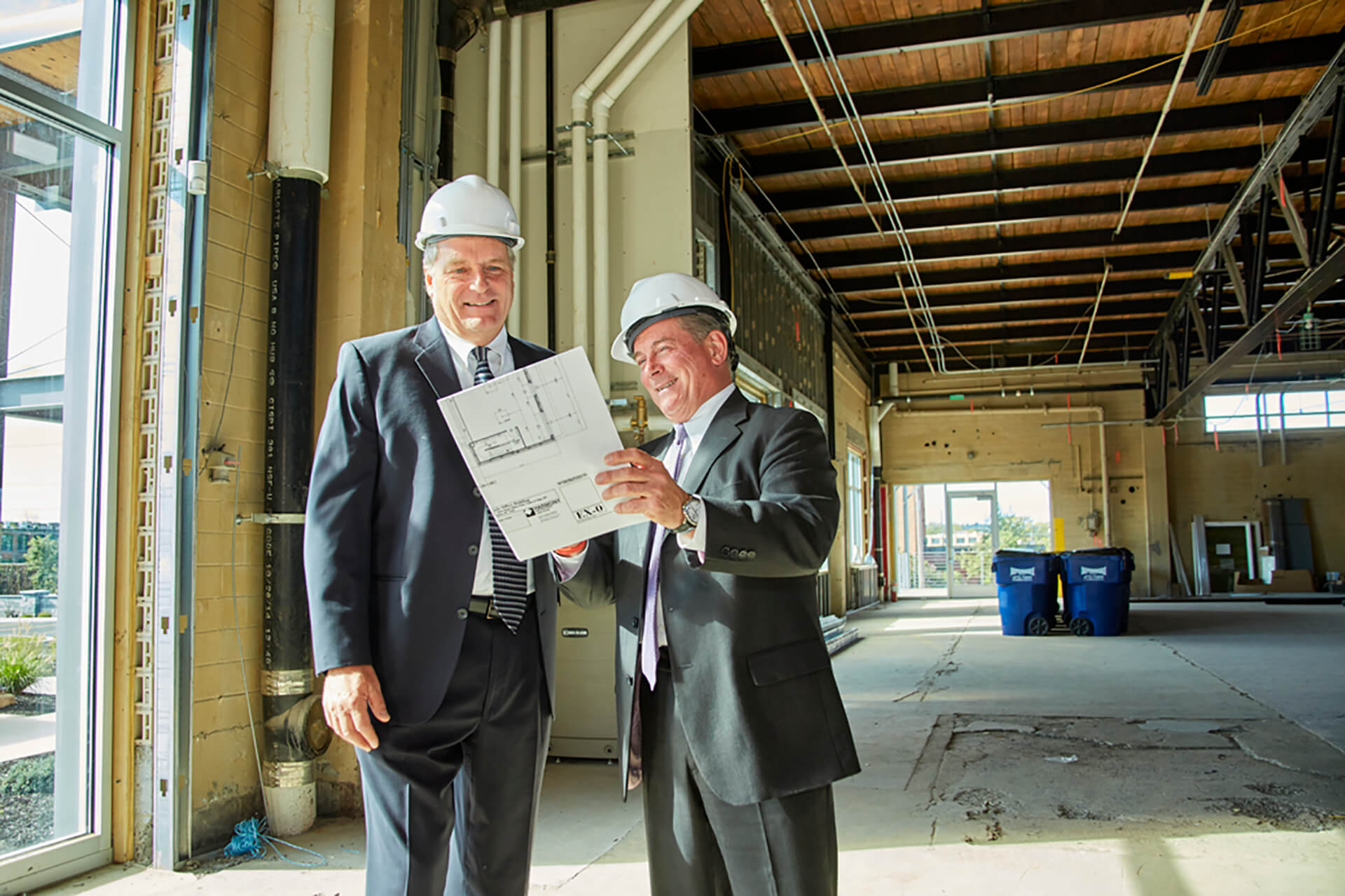 Two Men In Suits And Hardhats