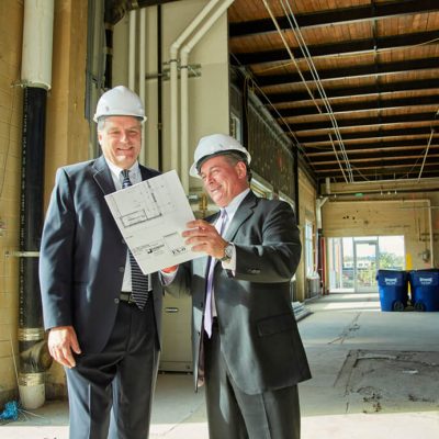 Two Men In Suits And Hardhats