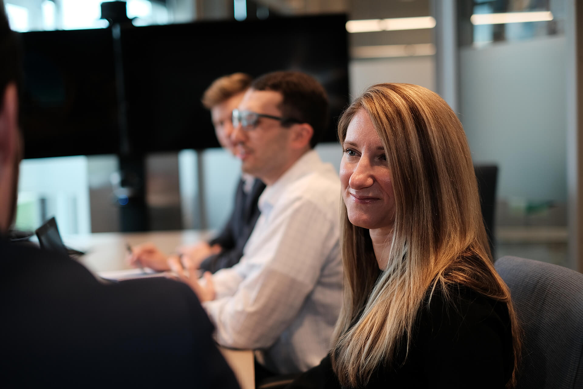 Woman Looking Towards Coworker In Discussion